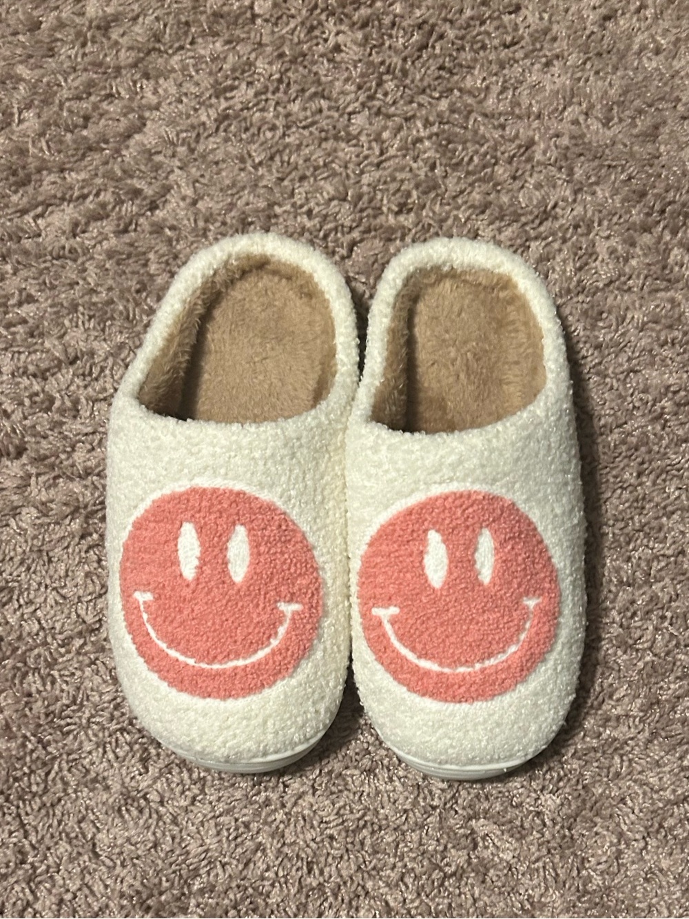 Soft and fuzzy pink and white smiley face slippers